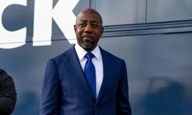 Then-Georgia US Senate Democratic Candidate Rev. Raphael Warnock meets with supporters on January 5