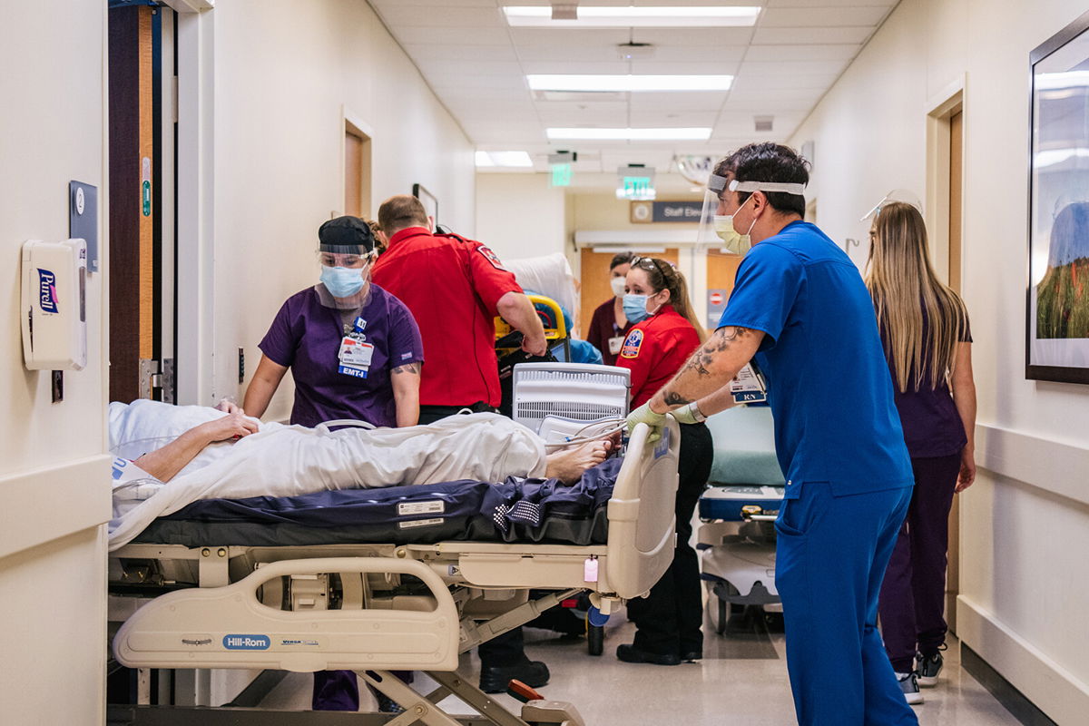 <i>Brandon Bell/Getty Images</i><br/>Texas health officials warn of full ICUs as the state grapples with a worsening Covid-19 surge. Nurses and EMTs tend to patients in hallways at the Houston Methodist The Woodlands Hospital on August 18