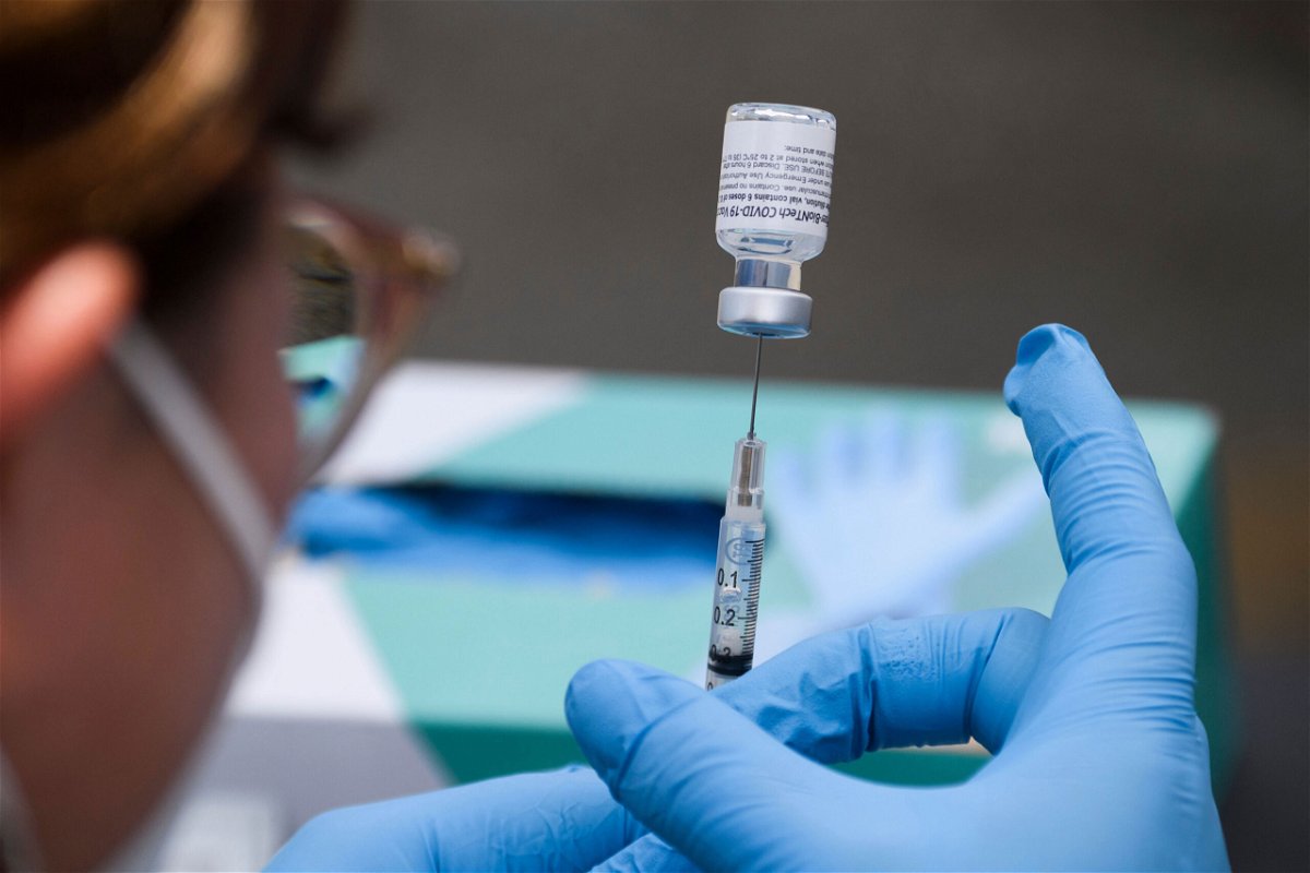 <i>Patrick T. Fallon/AFP/Getty Images</i><br />A syringe is filled with a first dose of the Pfizer Covid-19 vaccine at a mobile vaccination clinic in Los Angeles