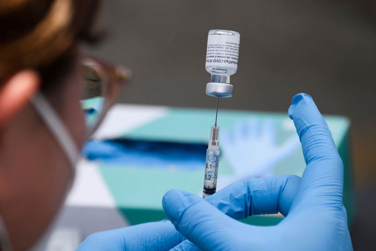 <i>Patrick T. Fallon/AFP/Getty Images</i><br/>A syringe is filled with a first dose of the Pfizer Covid-19 vaccine at a mobile vaccination clinic during a back to school event offering school supplies.