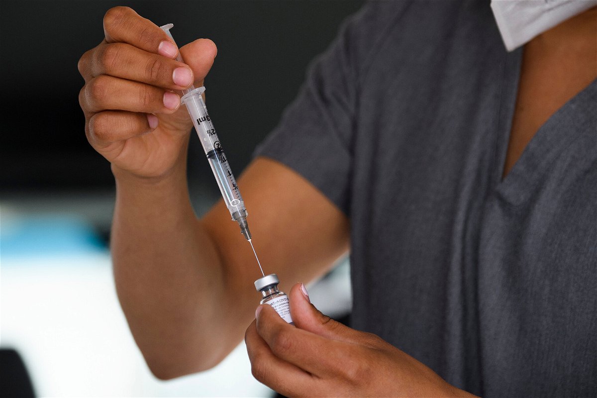 <i>Patrick T. Fallon/AFP/Getty Images</i><br/>More employers are mandating Covid-19 vaccines for their workers as the Delta variant surges across the United States