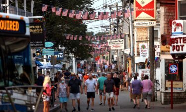 A Covid-19 outbreak in Provincetown helped change the CDC's mask guidance. People walk down Commercial Street in Provincetown on Tuesday