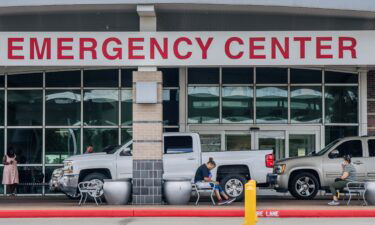 People wait outside of the Lyndon B. Johnson Hospital on August 10 in Houston. The hospital has set up medical tents in preparation for an overflow of patients being treated for the Covid-19 Delta variant.