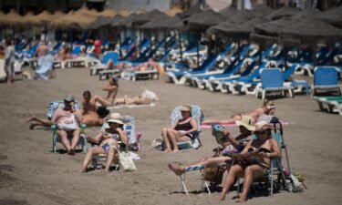 Tourists are seen sunbathing in Marbella