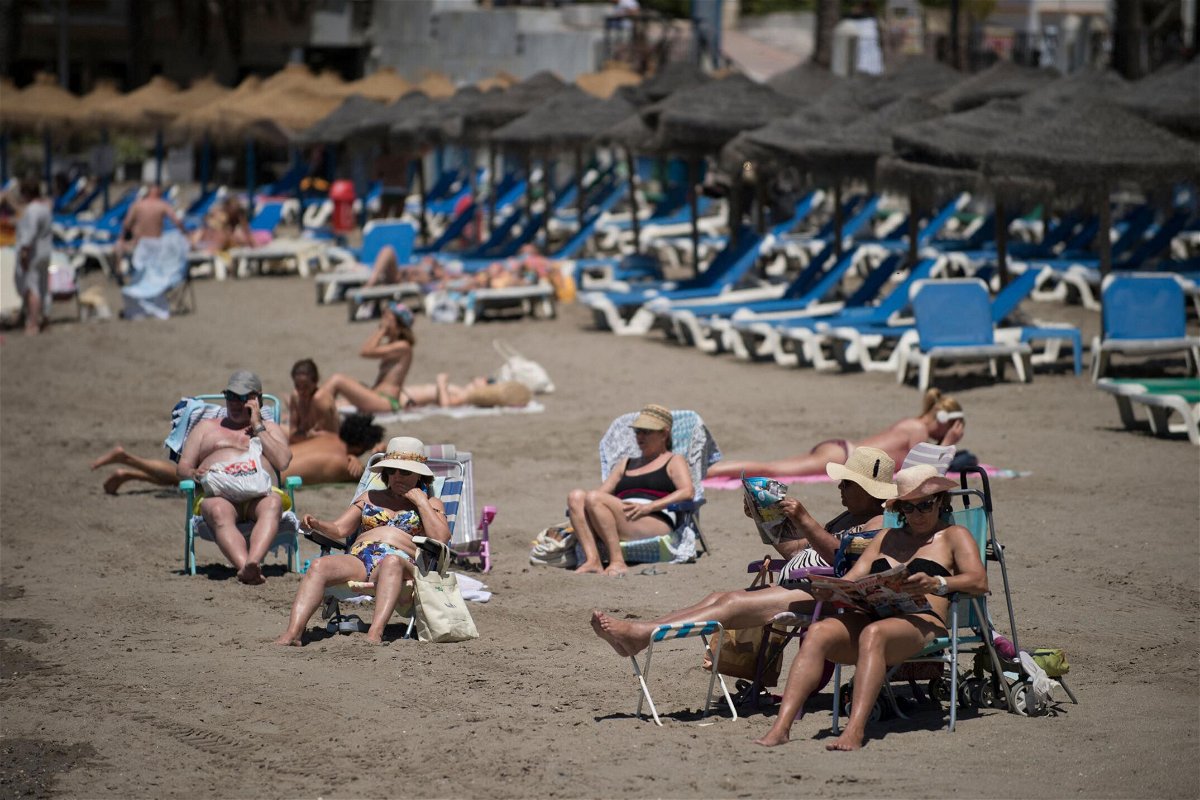 <i>Jorge Guerrero/AFP via Getty Images</i><br/>Tourists are seen sunbathing in Marbella