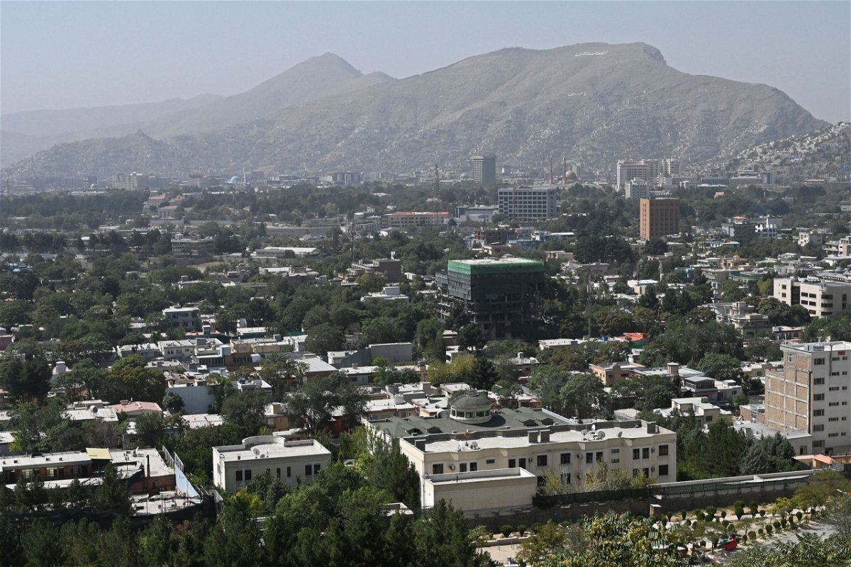 <i>Wakil Kohsar/AFP/Getty Images</i><br/>This picture taken from the top of a hillside shows a general view of the Kabul city on August 15. News outlets including CNN and the Washington Post are working overtime to ensure the safety of staffers in Afghanistan after the Taliban took control of the country.