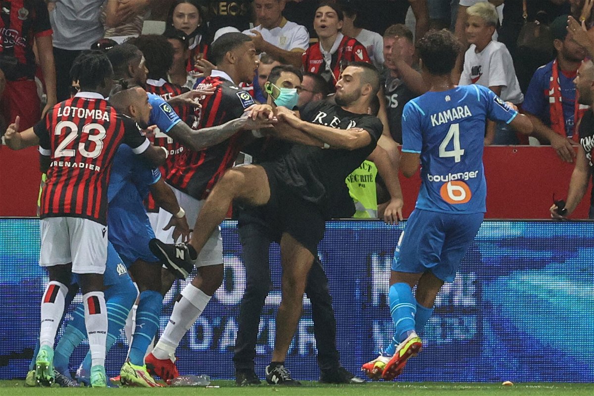 <i>Valery Hache/AFP/Getty Images</i><br/>Dimitri Payet (second left) reacts as players from Nice and Marseille stop a fan invading the pitch.