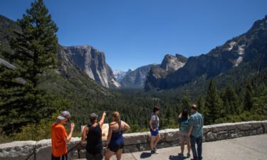 Visitors walk to the Tunnel View lookout in Yosemite Valley at Yosemite National Park