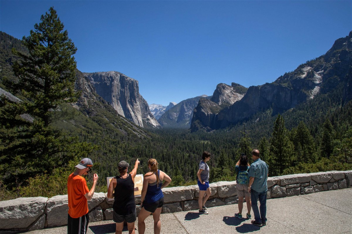 <i>Apu Gomes/AFP/Getty Images</i><br/>Visitors walk to the Tunnel View lookout in Yosemite Valley at Yosemite National Park