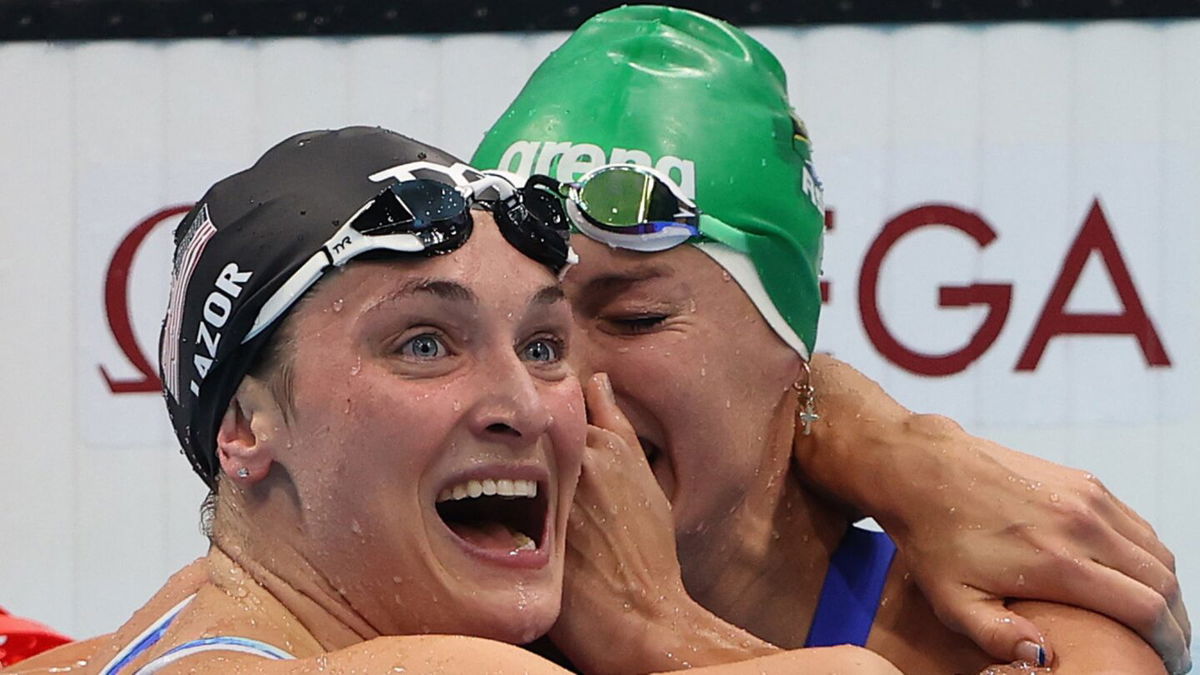 Tatjana Schoenmaker of Team South Africa celebrates with Annie Lazor of United States after winning the gold medal and breaking the world record after competing in the Women's 200m Breaststroke Final on day seven of the Tokyo 2020 Olympic Games