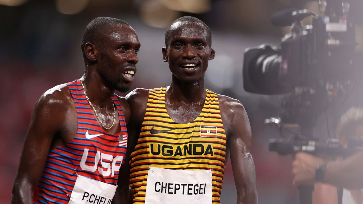 Bronze medal winner Paul Chelimo of Team USA and gold medal winner Joshua Cheptegei of Team Uganda celebrate after the Men's 5000 metres final day fourteen of the Tokyo 2020 Olympic Games