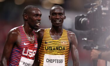 Bronze medal winner Paul Chelimo of Team USA and gold medal winner Joshua Cheptegei of Team Uganda celebrate after the Men's 5000 metres final day fourteen of the Tokyo 2020 Olympic Games