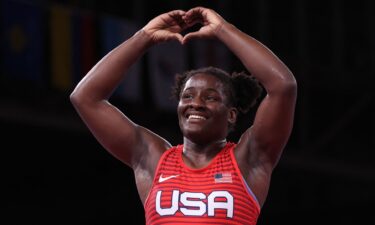 Tamyra Mariama Mensah-Stock celebrate her gold medal victory against Nigeria's Blessing Oborududu in their women's freestyle 68kg wrestling final match during the Tokyo 2020 Olympic Games