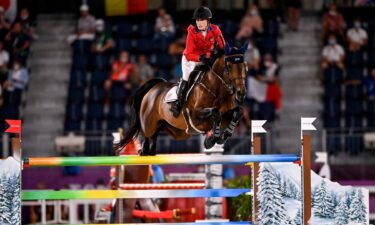 Jessica Springsteen and Don Juan go over a multi-colored jump with sides painted like snow