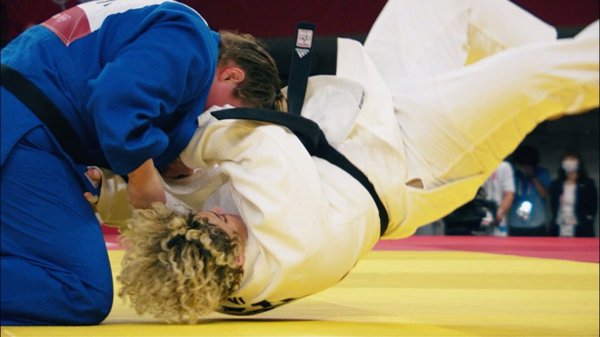 Two Olympians in the judo tournament hit the mat after a takedown