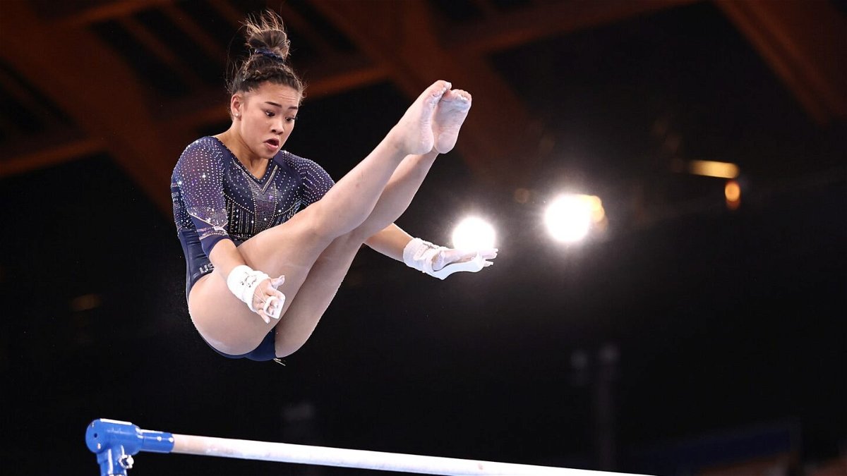 Suni Lee competes on the uneven bars during event finals at the Tokyo Olympics