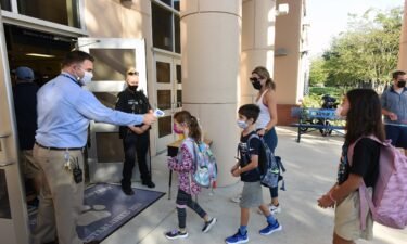 A Florida judge on Wednesday allowed schools in the state to mandate face masks while the case is appealed. Students here arrive on the first day of classes for the 2021-22 school year at Baldwin Park Elementary School.