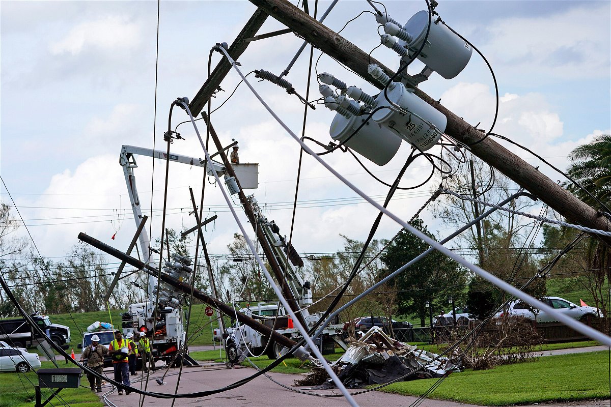 <i>Steve Helber/AP</i><br/>Crews begin work on downed power lines leading to a fire station