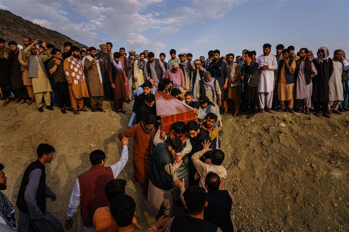 <i>Marcus Yam/The Los Angeles Times/Shutterstock</i><br/>Caskets for the dead are carried towards the gravesite as relatives and friends attend a mass funeral for members of a family that is said to have been killed in a U.S. drone airstrike