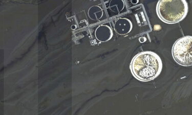 This image provided by NOAA taken on August 31 and reviewed by The Associated Press shows oil slicks at the flooded Phillips 66 Alliance Refinery in Belle Chasse