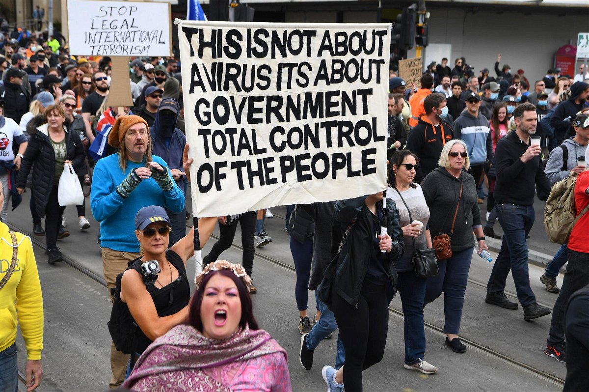 <i>William West/AFP/Getty Images</i><br/>Protesters march through the streets during an anti-lockdown rally in Melbourne on Sept. 18.