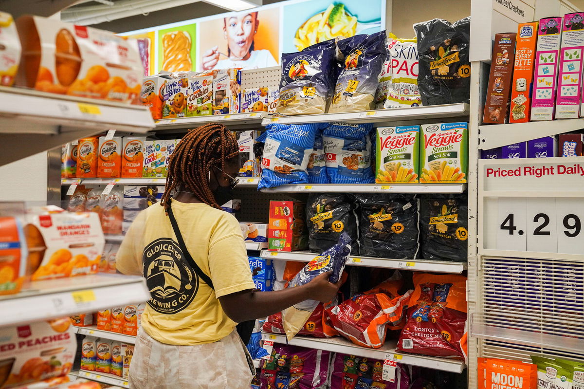 <i>Wang Ying/Xinhua/Getty Images</i><br/>US inflation eased in August. A customer here selects goods at a supermarket in New York