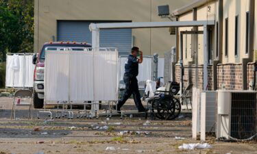 An EMS technician walks near the mass shelter in Independence