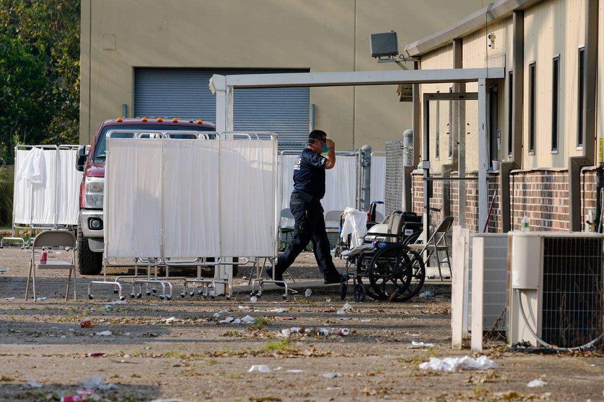 <i>Steve Helber/AP</i><br/>An EMS technician walks near the mass shelter in Independence