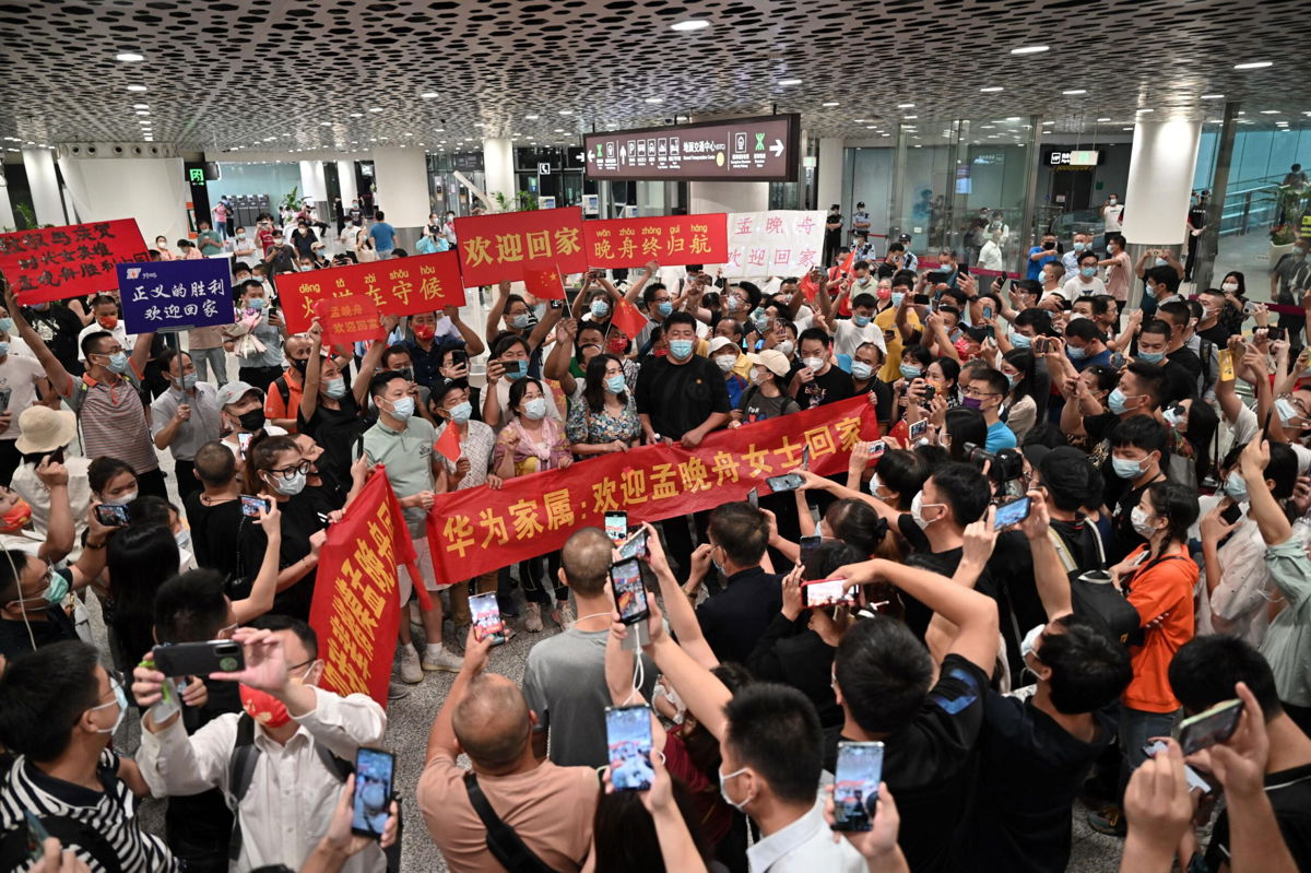 <i>Visual China Group/Getty Images</i><br/>Crowds hold banners and placards reading 