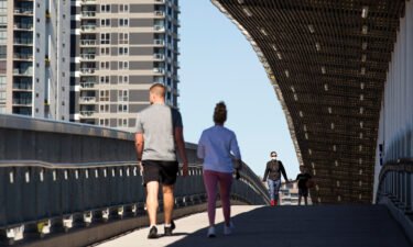 Local residents walk over a bridge on August 4 in Brisbane