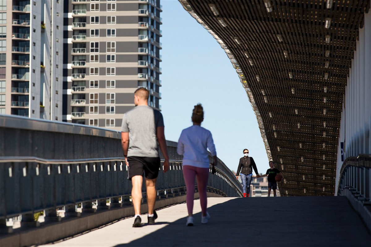 <i>Jono Searle/Getty Images</i><br/>Local residents walk over a bridge on August 4 in Brisbane