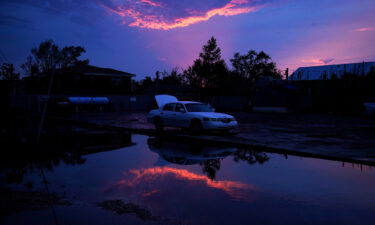 Car prices are about to soar again. Blame Hurricane Ida. A damaged car sits beside floodwaters in the aftermath of Hurricane Ida in Jean Lafitte