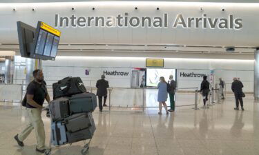 Passengers arrive at the international arrivals hall at London Heathrow Airport on July 29