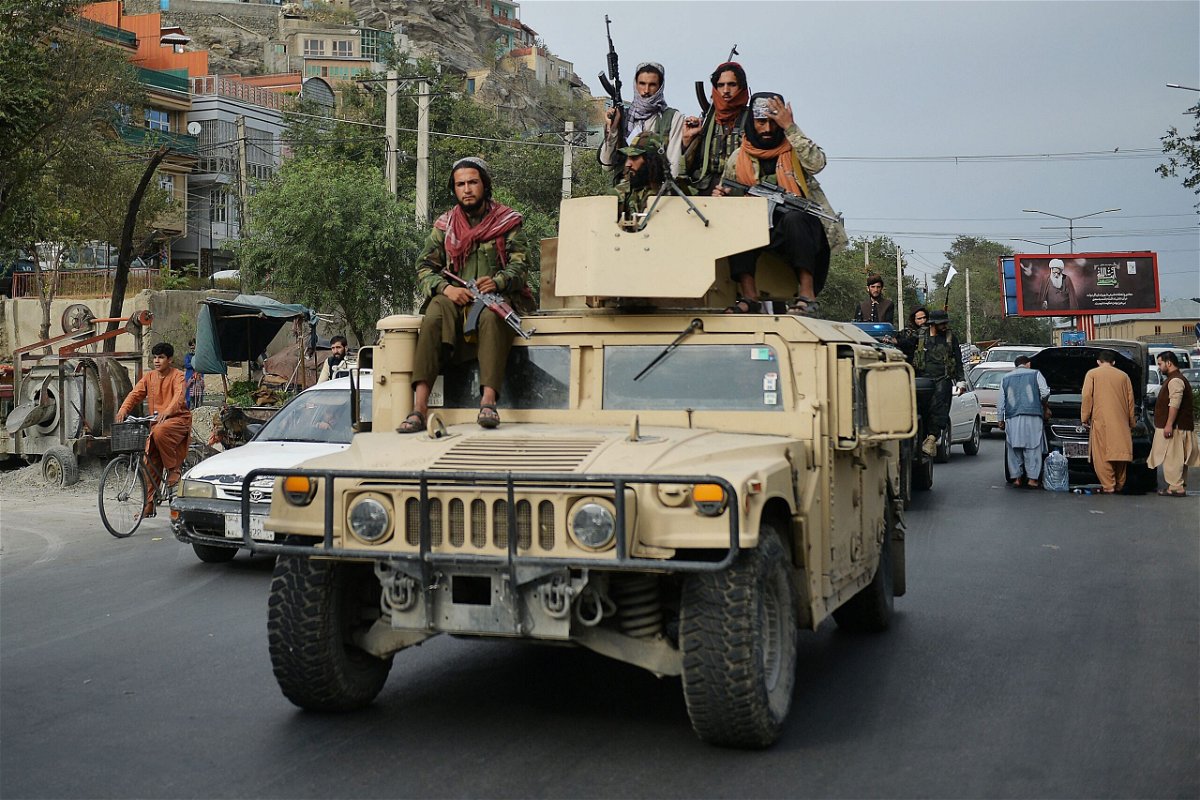 <i>Hoshang Hashimi/AFP via Getty Images</i><br/>The Taliban have announced Tuesday the formation of a hardline interim government for Afghanistan. Taliban fighters atop a Humvee vehicle are seen here in Kabul on August 31.