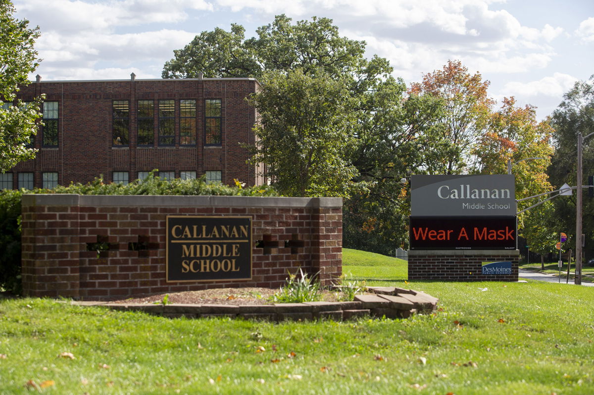 <i>Rachel Mummey/Bloomberg/Getty Images</i><br/>Des Moines Public Schools officials will reinstate the district's mask mandate Wednesday. A sign reminds people to wear a mask outside Callanan Middle School in Des Moines