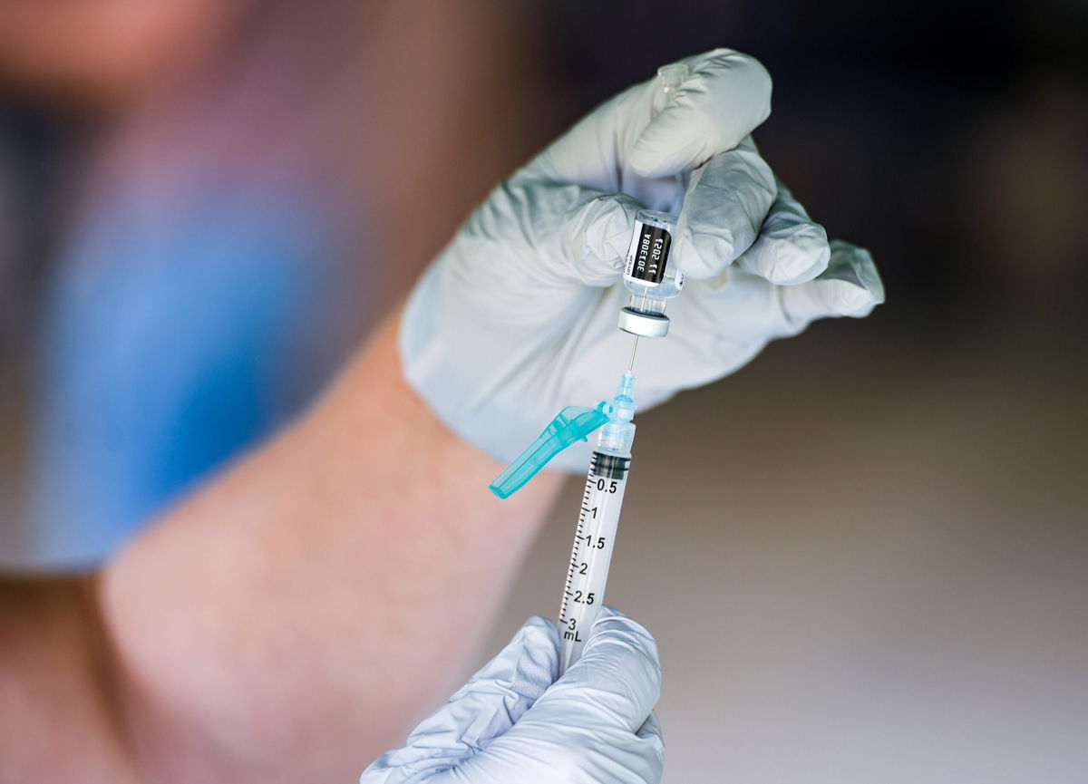 <i>Ben Hasty/MediaNews Group/Reading Eagle/Getty Images</i><br/>A nurse fills a syringe with a dose of BioNTech