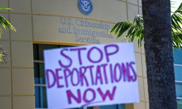 Demonstrators protest outside the US Citizenship and Immigration Service office in Miami