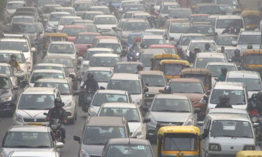 Motorists drive amid heavy smog in New Delhi on November 14