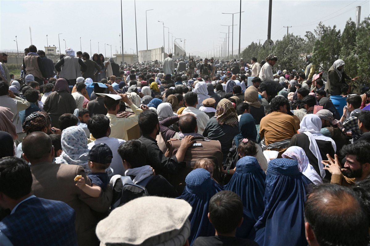 <i>Wakil Kohsar/AFP/Getty Images</i><br/>Afghans gather on a roadside near the airport in Kabul on August 20