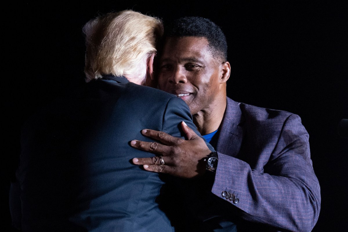 <i>Ben Gray/AP</i><br/>Former President Donald Trump hugs Georgia Senate candidate Herschel Walker during his Save America rally in Perry