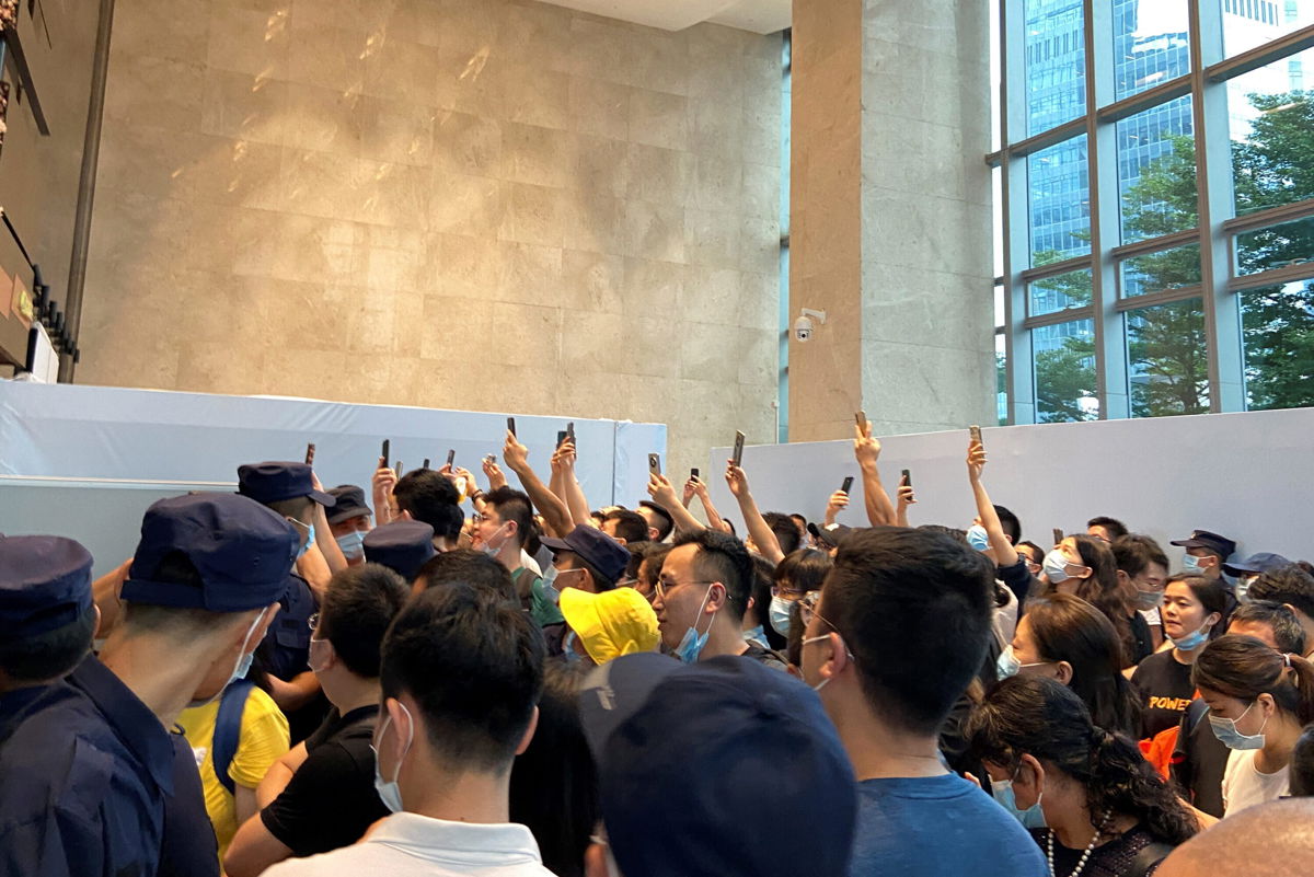 <i>David Kirton/Reuters</i><br/>People gathering to demand repayment of loans and financial products at Evergrande's headquarters in Shenzhen on Monday.