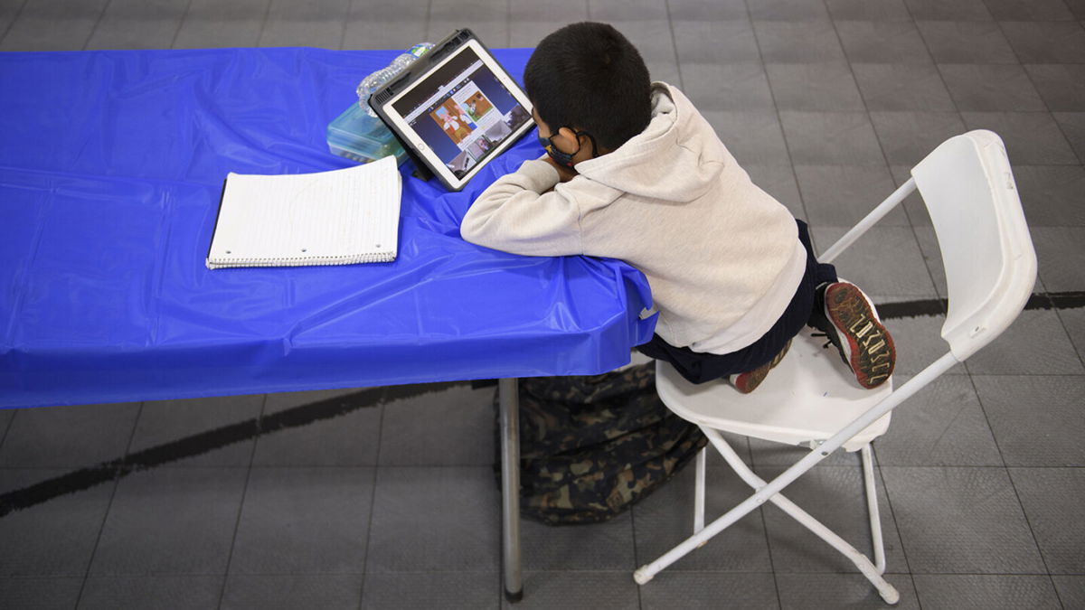 <i>Patrick T. Fallon/AFP/Getty Images</i><br/>A child attends an online class at a learning hub inside the Crenshaw Family YMCA in Los Angeles