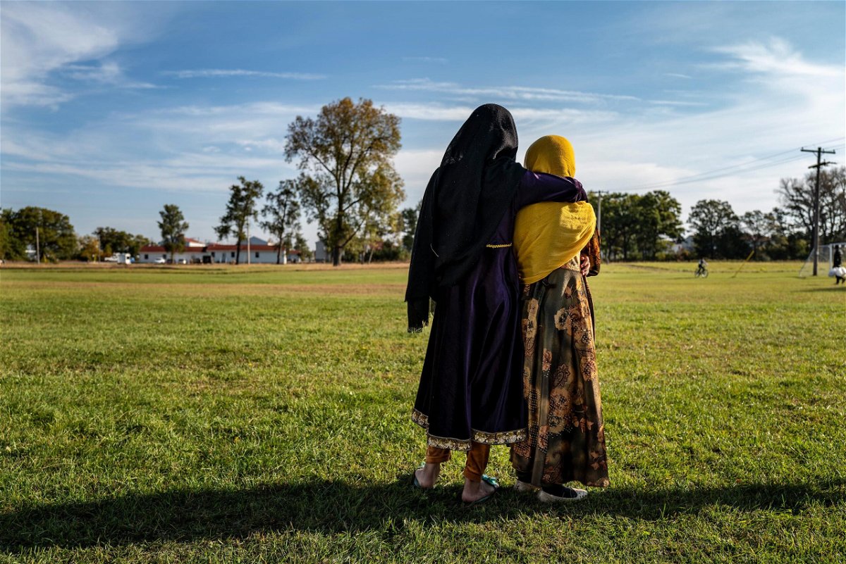 <i>Barbara Davidson/Getty Images</i><br/>Afghan refugee girls watch a soccer match near where they are staying in the Village at the Ft. McCoy U.S. Army base on September 30 in Ft. McCoy