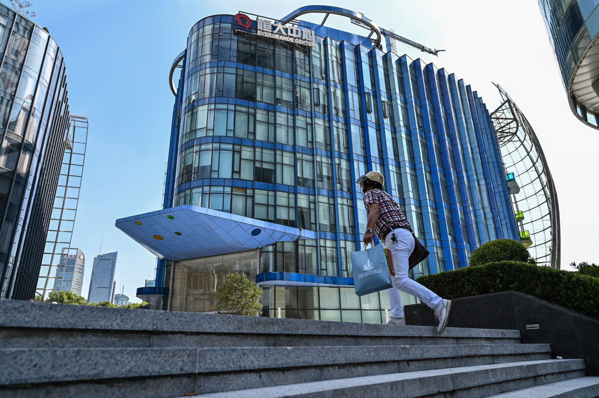 <i>Hector Retamal/AFP/Getty Images</i><br/>Evergrande raises $1.5 billion as another debt payment looms. Pictured is the Evergrande Center building in Shanghai.