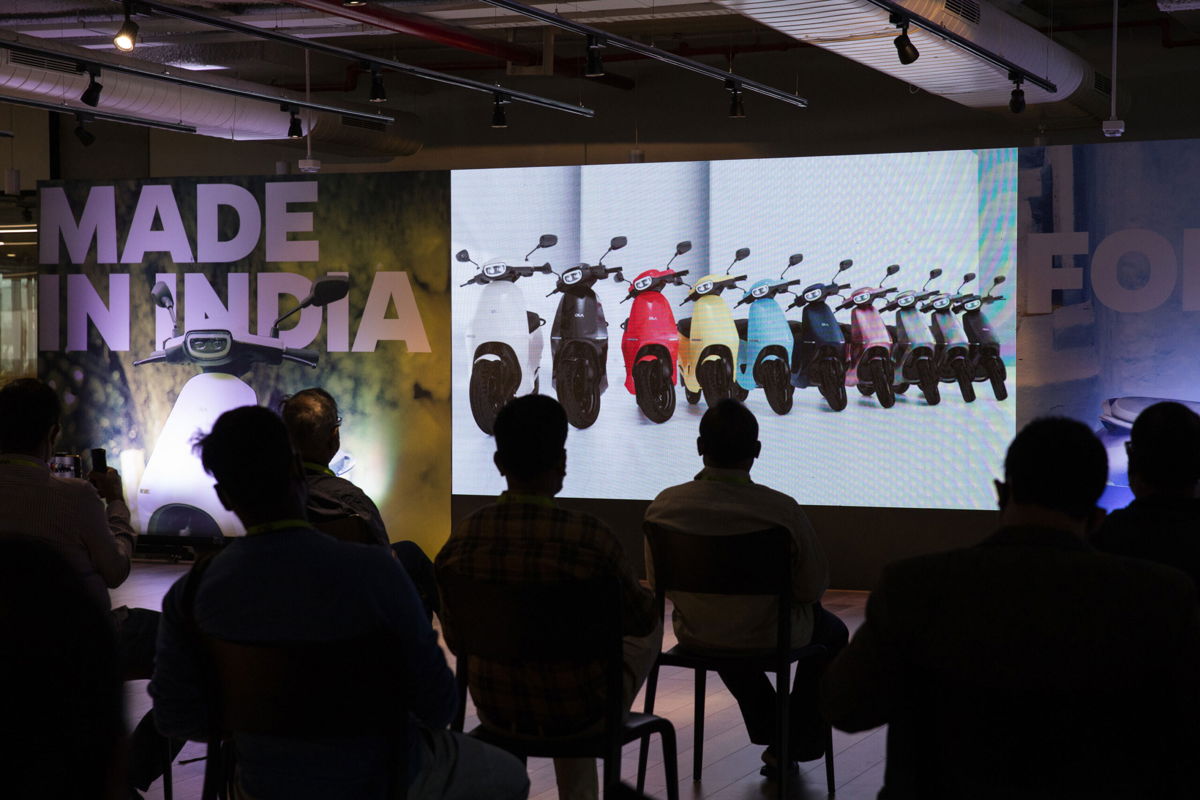 <i>Samyukta Lakshmi/Bloomberg/Getty Images</i><br/>Attendees listen to presentations on a screen during the launch of the Ola Electric Scooter at the Ola Campus in Bengaluru