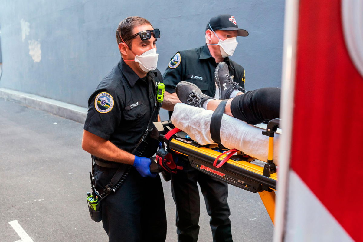 <i>Nathan Howard/AP</i><br/>Paramedics respond to a heat exposure call during a heat wave in Salem