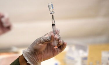 A healthcare worker prepares a syringe with a vial of the J&J/Janssen Covid-19 vaccine at a temporary vaccination site at Grand Central Terminal train station on May 12 in New York City.