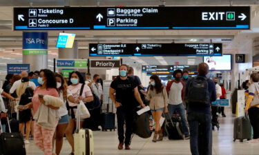 Travelers make their way through the Miami International Airport on September 3 in Miami