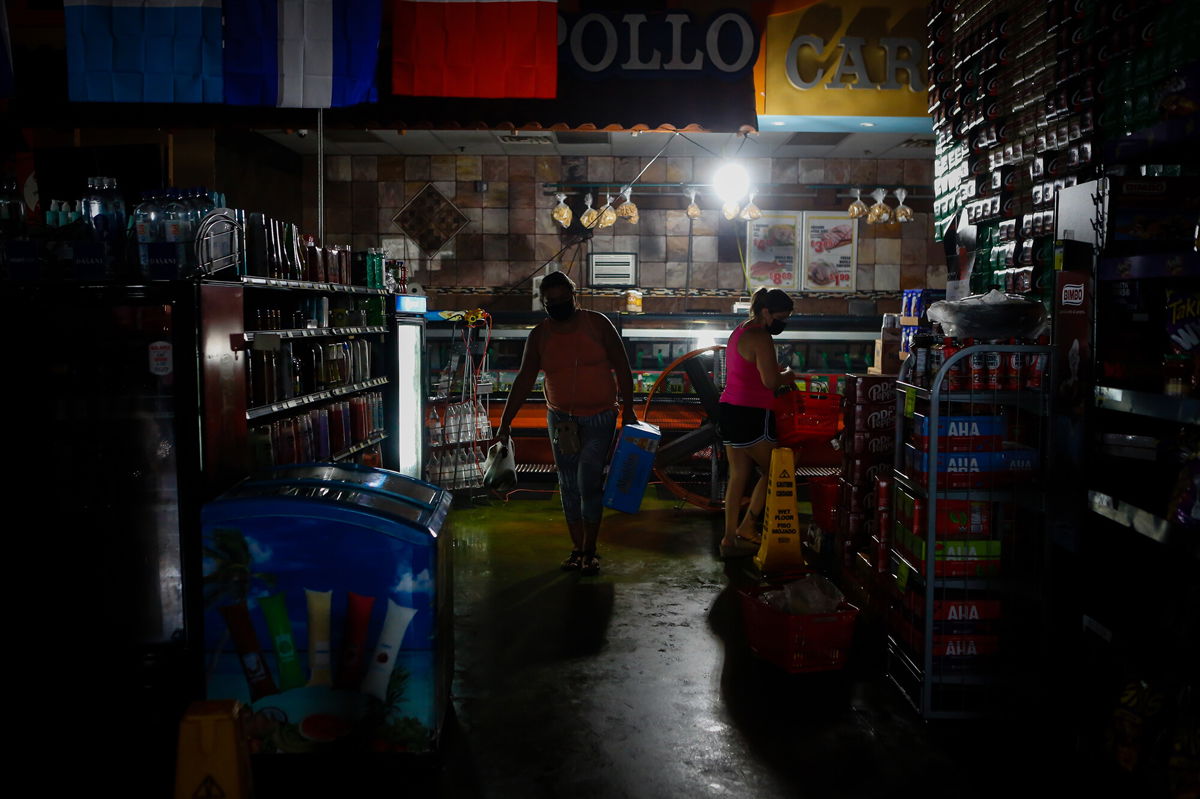 <i>Eva Marie Uzcategui/Bloomberg/Getty Images</i><br/>Shoppers buy supplies at a grocery store during the blackout after Hurricane Ida in New Orleans