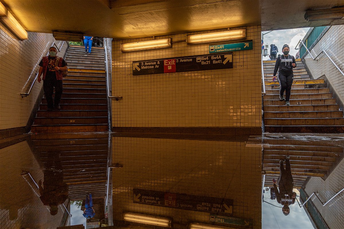 <i>David Dee Delgado/Getty Images</i><br/>Commuters walk into a flooded 3rd Avenue / 149th st subway station and disrupted service due to extremely heavy rainfall from the remnants of Hurricane Ida on September 2